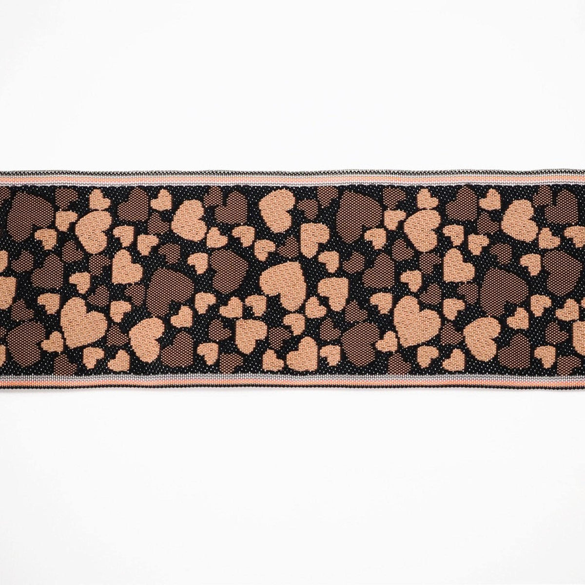 a close-up view of a fabric with a heart pattern, consisting of brown and black hearts on a white background.