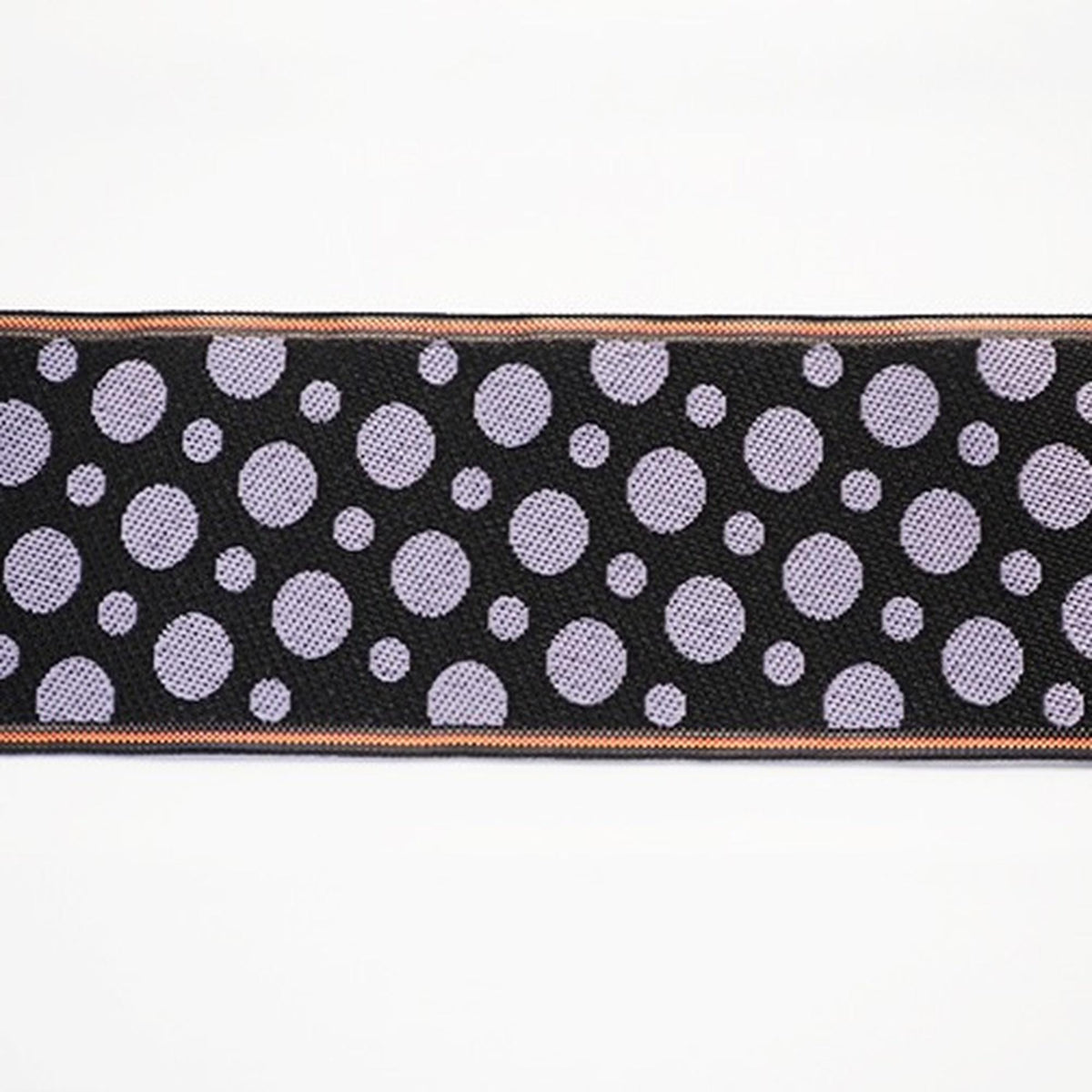 a close-up view of a black and white fabric with a repeating pattern of purple circles on a white background.