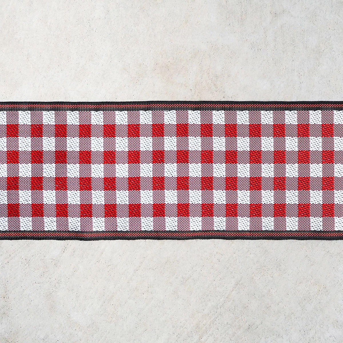 A red and white checkered pattern on a white surface.