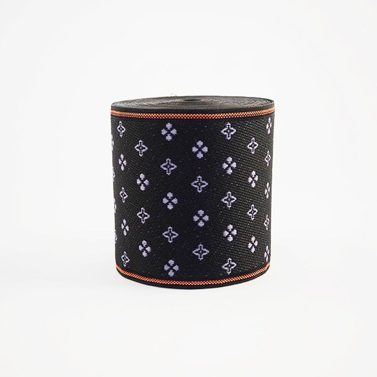 a black cylindrical object with a repeating pattern of purple and white flowers or shapes on its surface.