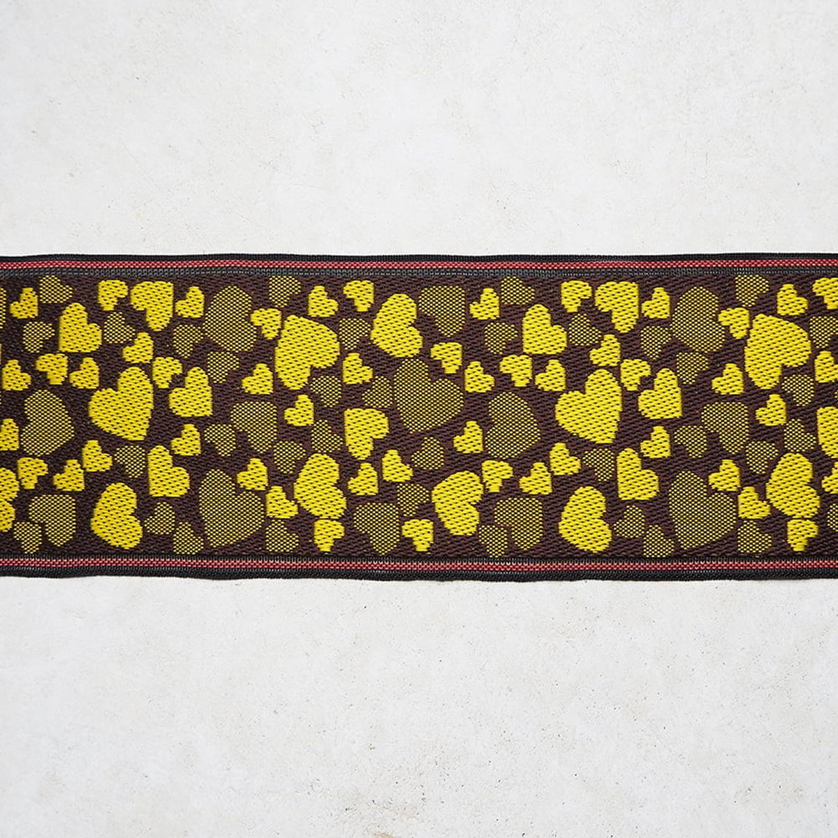 a pattern of yellow hearts on a dark background, creating a visually striking contrast.