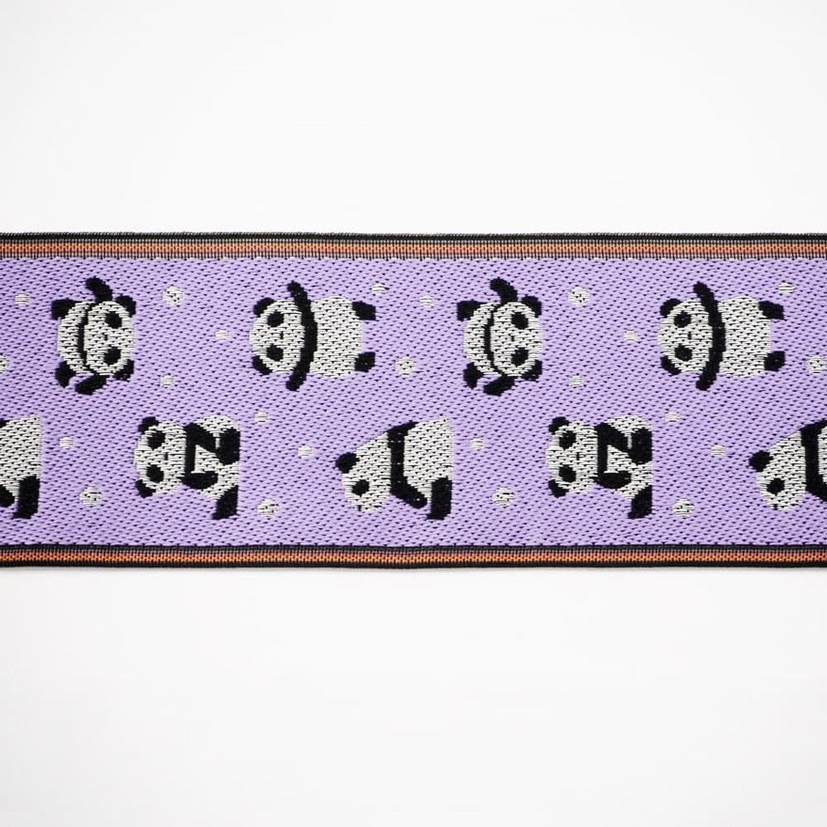 a repeating pattern of panda silhouettes on a purple background.