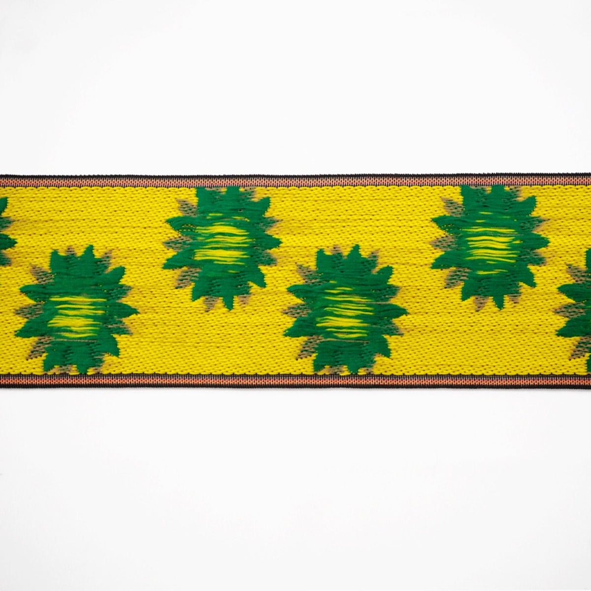 a vibrant yellow and green patterned fabric with a repeating design of green leaves on a yellow background.