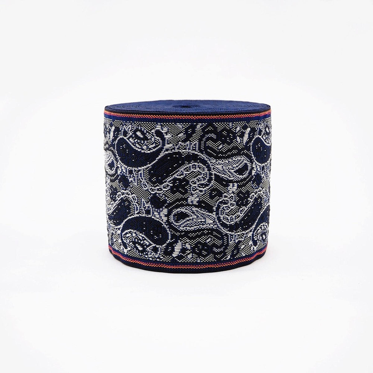 A cylindrical object with a blue and white paisley pattern, featuring a red border around the edge.