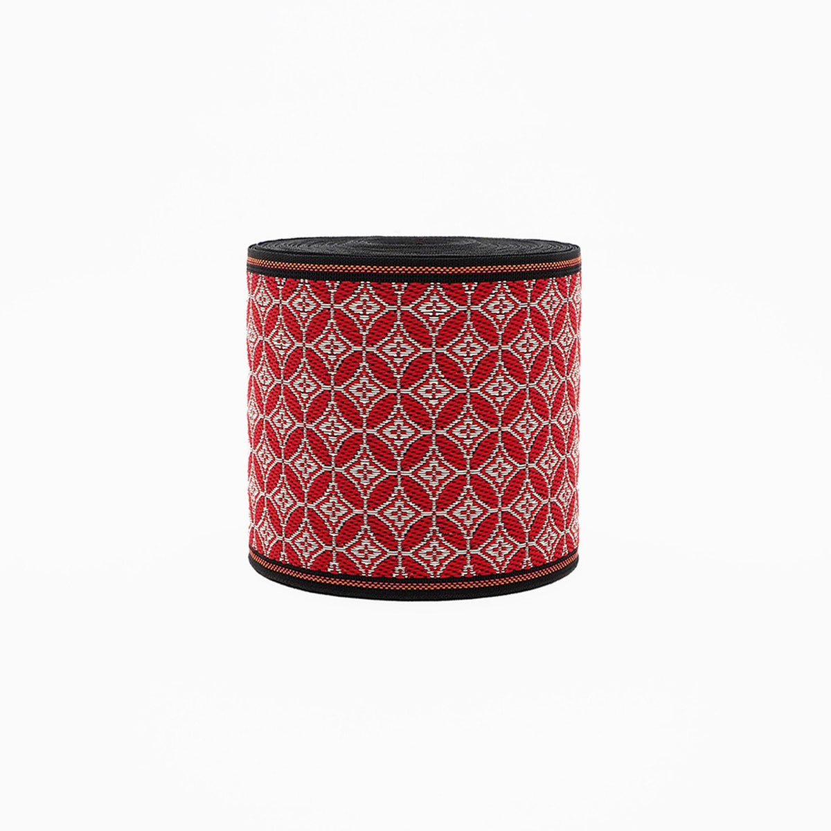 a cylindrical object with a red and white patterned design on its surface.