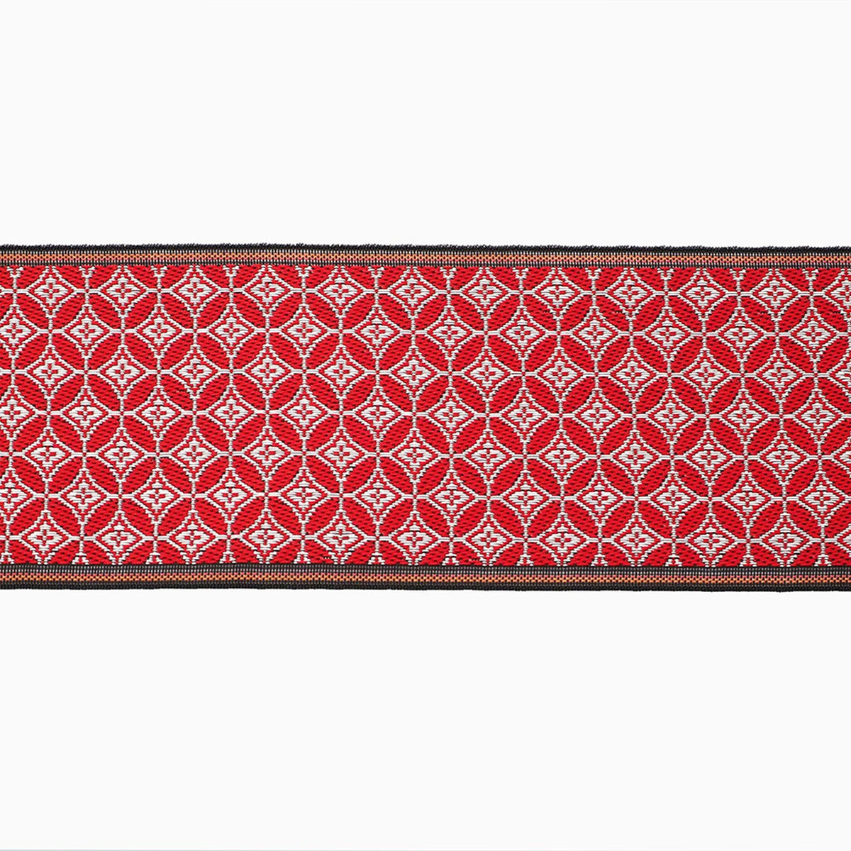 a red and white patterned fabric with a black border.