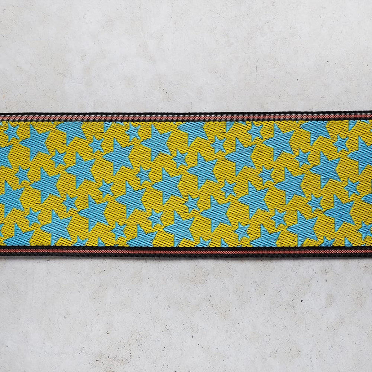 a vibrant, colorful pattern of yellow and blue stars on a white background.