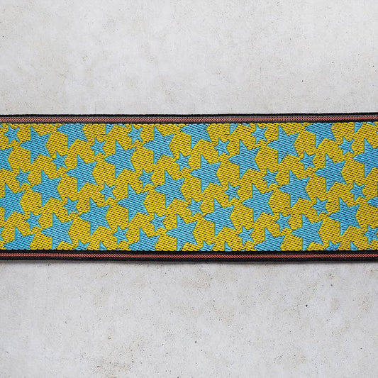 a vibrant, colorful pattern of yellow and blue stars on a white background.