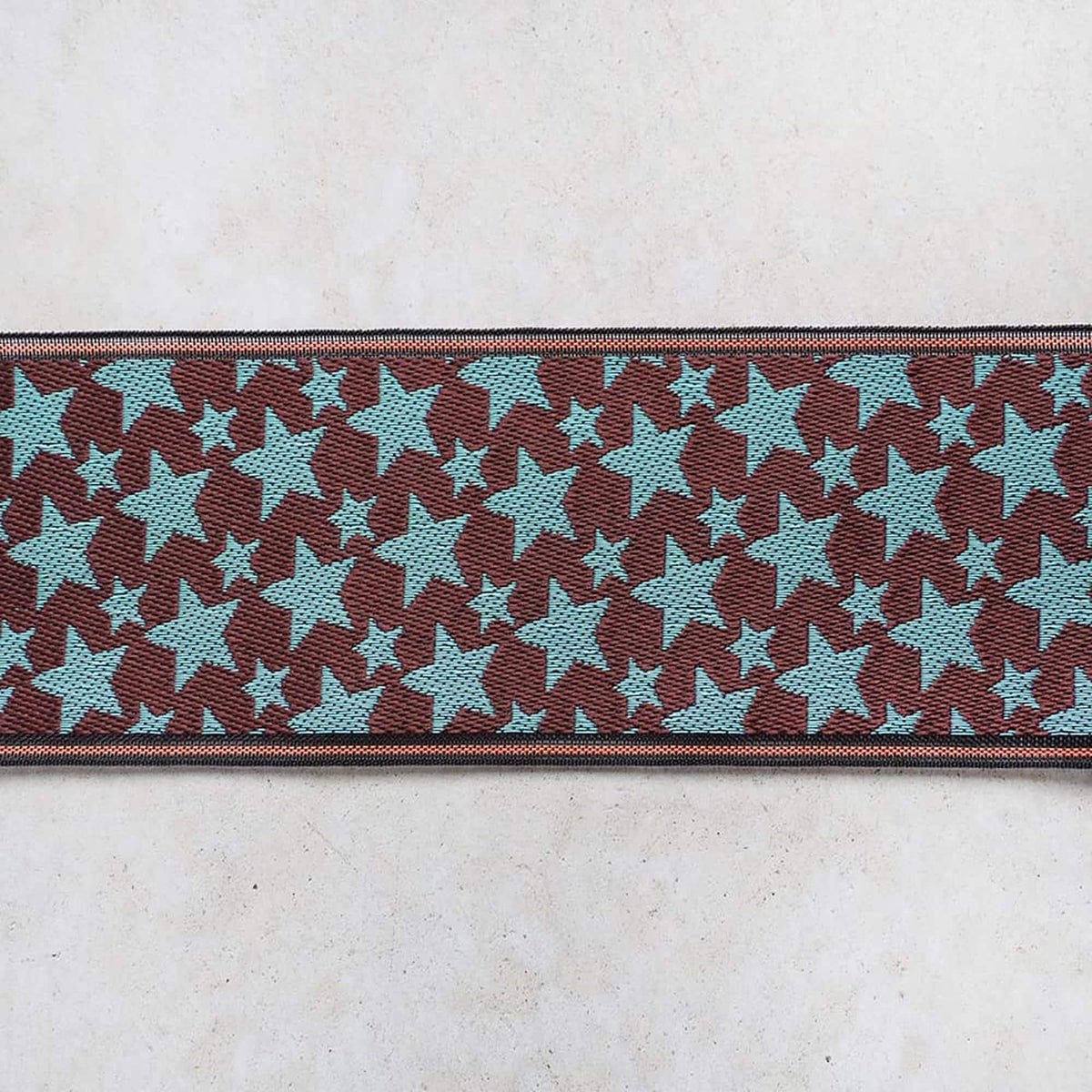 a repeating pattern of brown and blue stars on a white background.