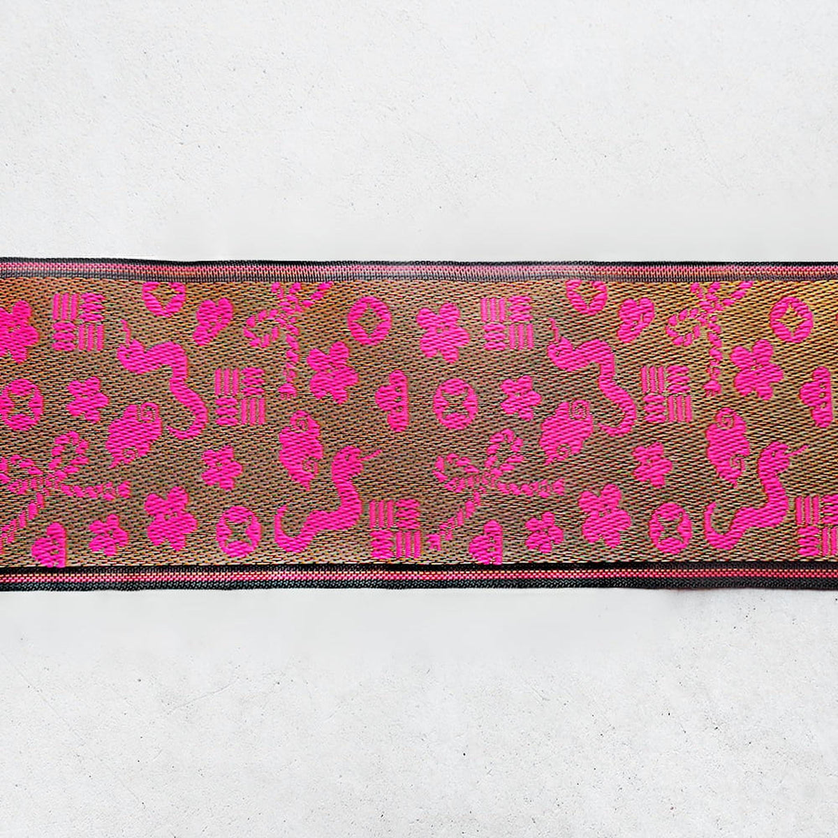 a decorative fabric with a repeating pattern of pink flowers and leaves.