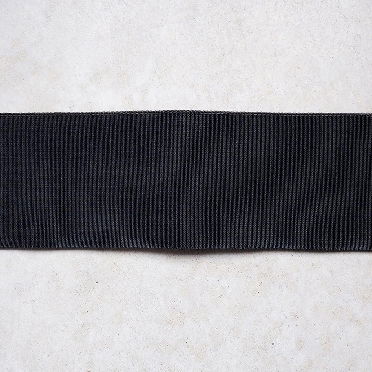 A black rubber band is shown against a white background.