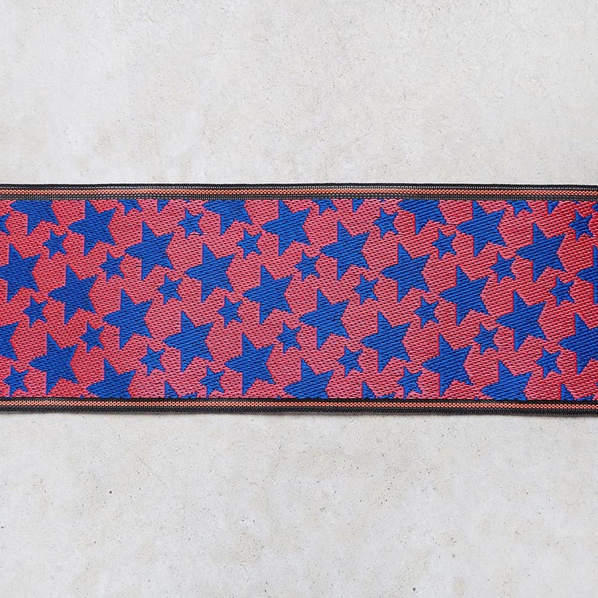 a repeating pattern of red and blue stars on a white background.
