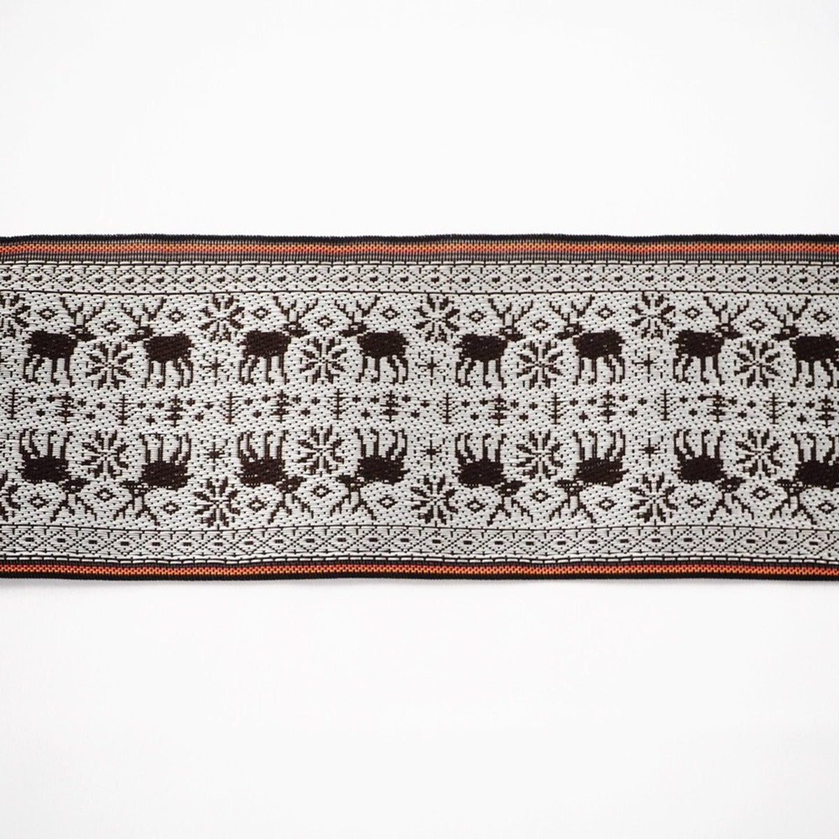 a decorative border with a repeating pattern of black silhouettes of deer and snowflakes.