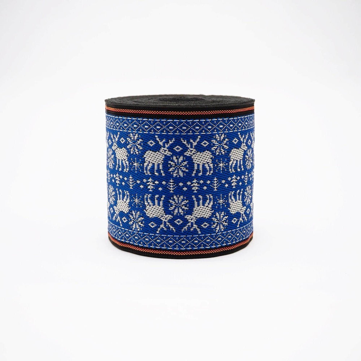 A cylindrical object with a blue and white patterned design, featuring deer and snowflakes.