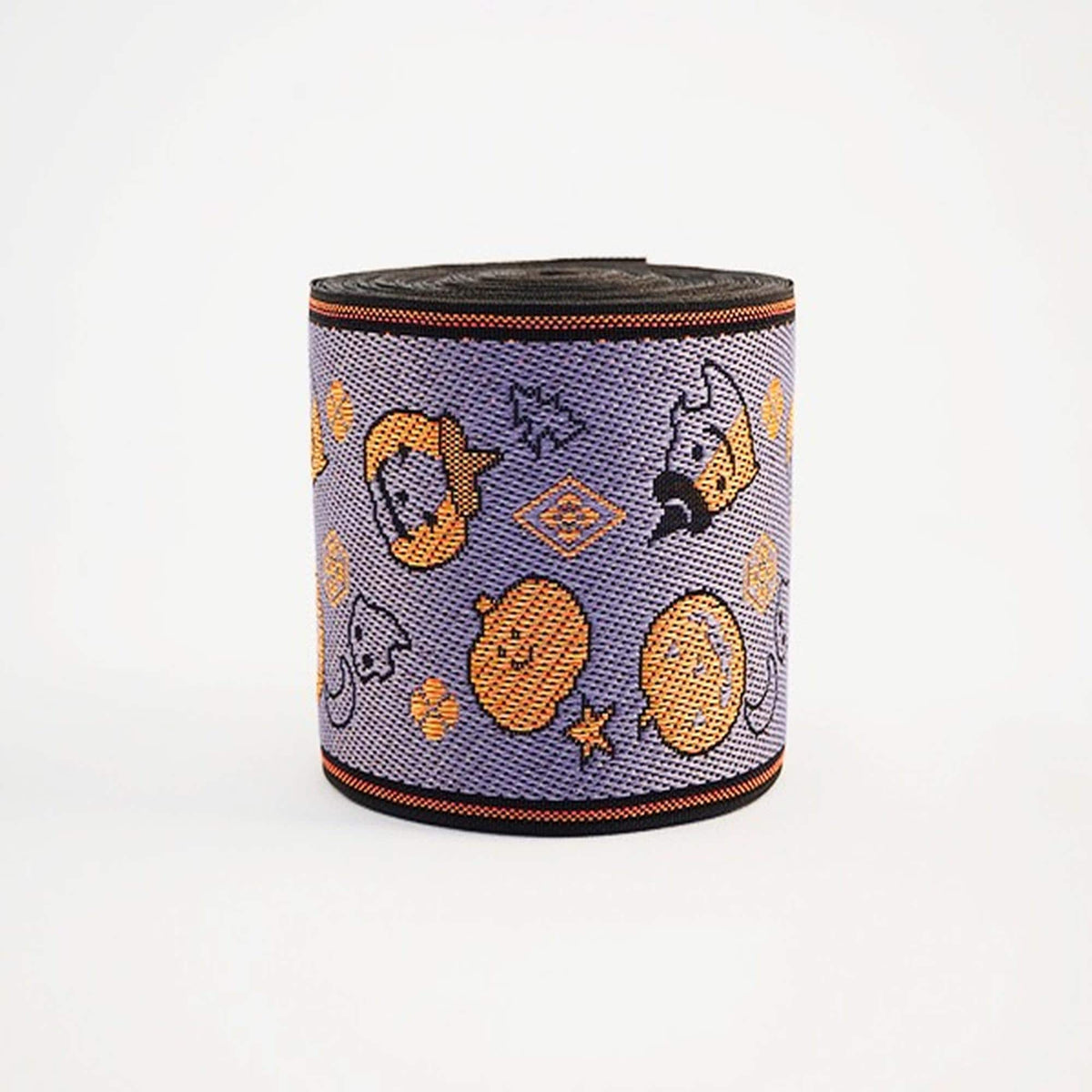 a Halloween-themed spool of purple fabric with various cartoon-like characters and designs, including a skull, a pumpkin, and other Halloween-related motifs.