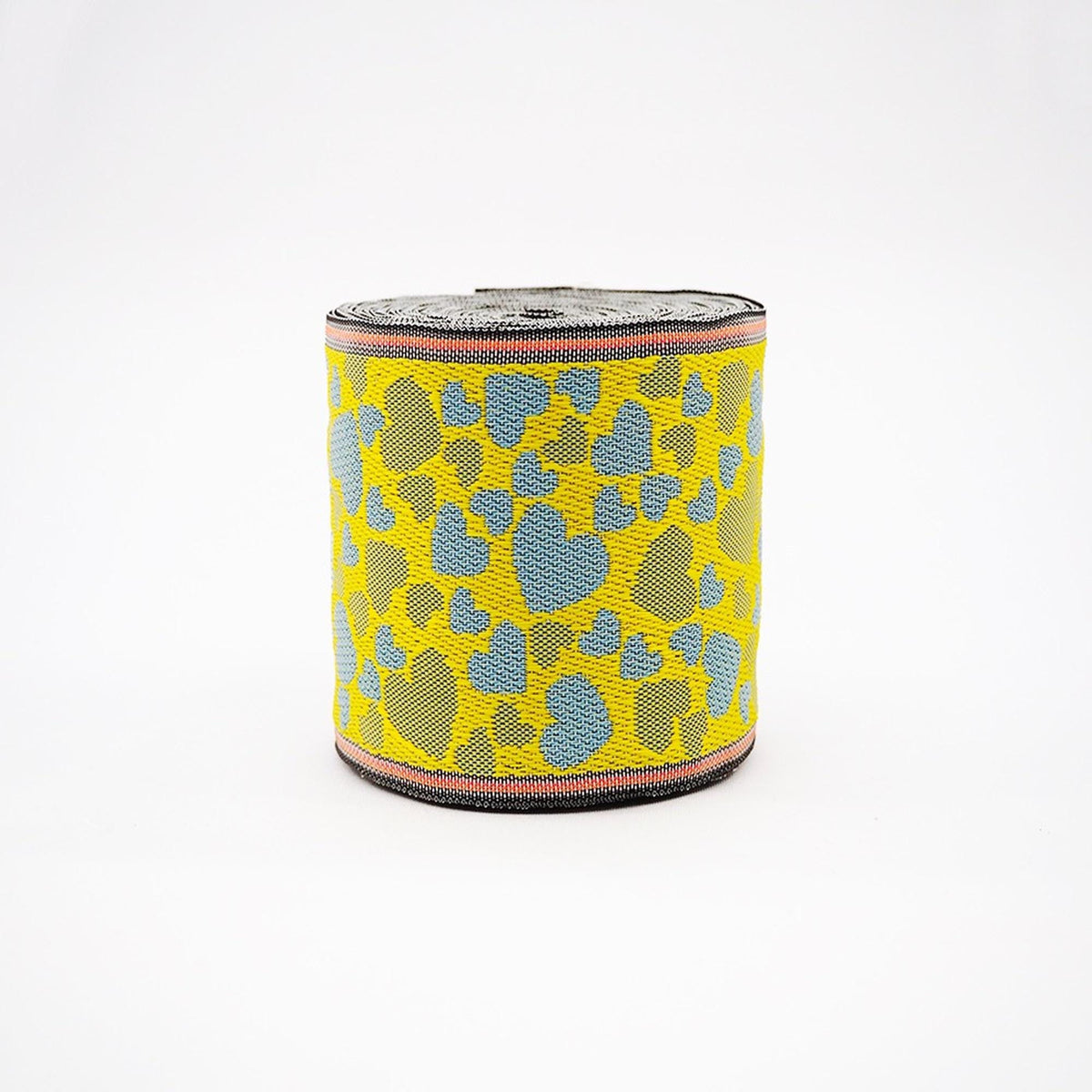 A colorful, textured object with a pattern of yellow and blue shapes, resembling a piece of fabric or a decorative item.
