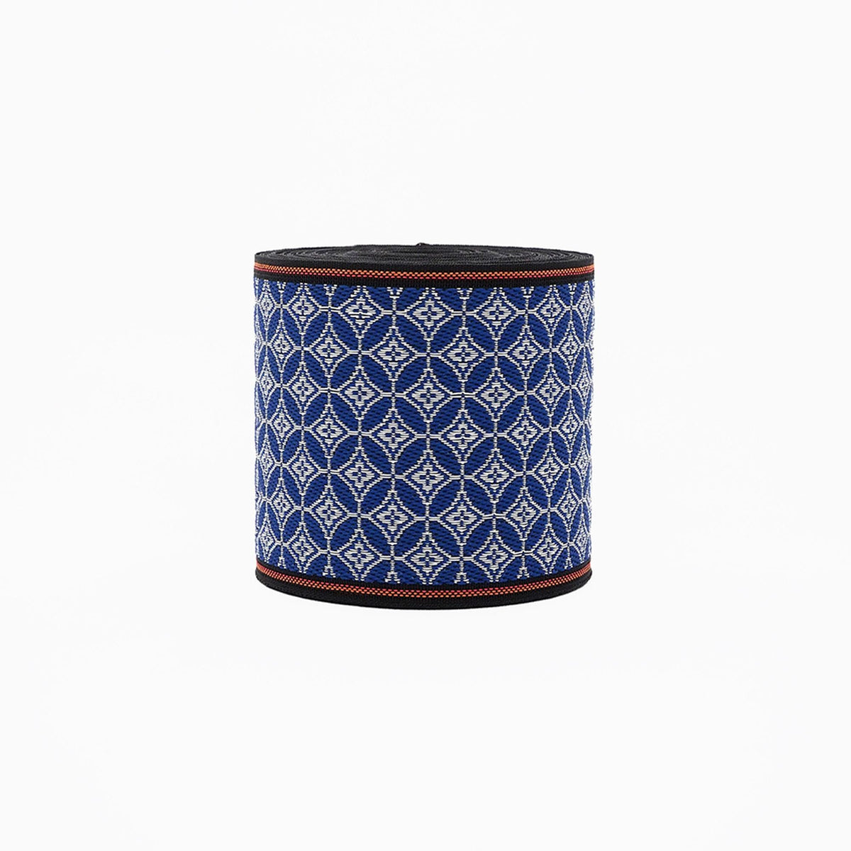 A cylindrical object with a blue and white geometric pattern, featuring a black border around the top edge.