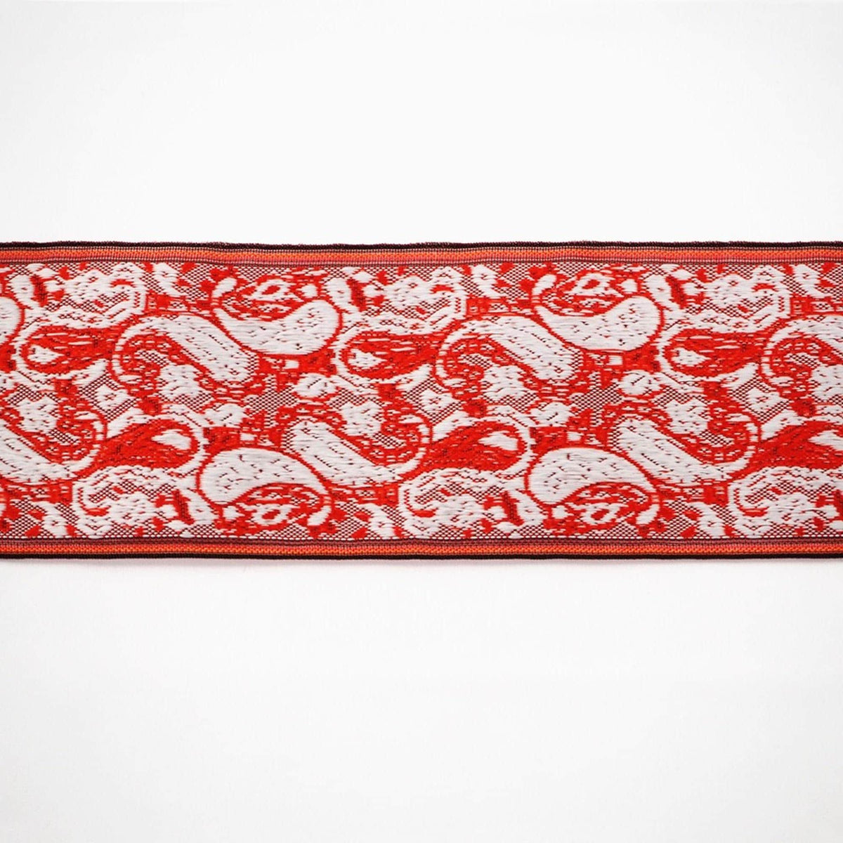 a red and white paisley pattern with a repeating design of red and white swirls and shapes.