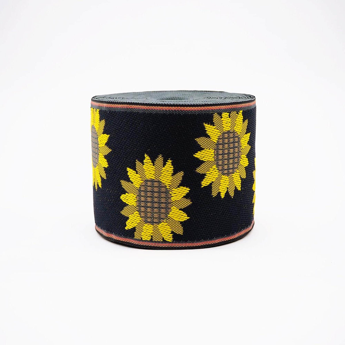A black and yellow sunflower-patterned fabric or material, possibly a ribbon or fabric item, is shown against a white background.