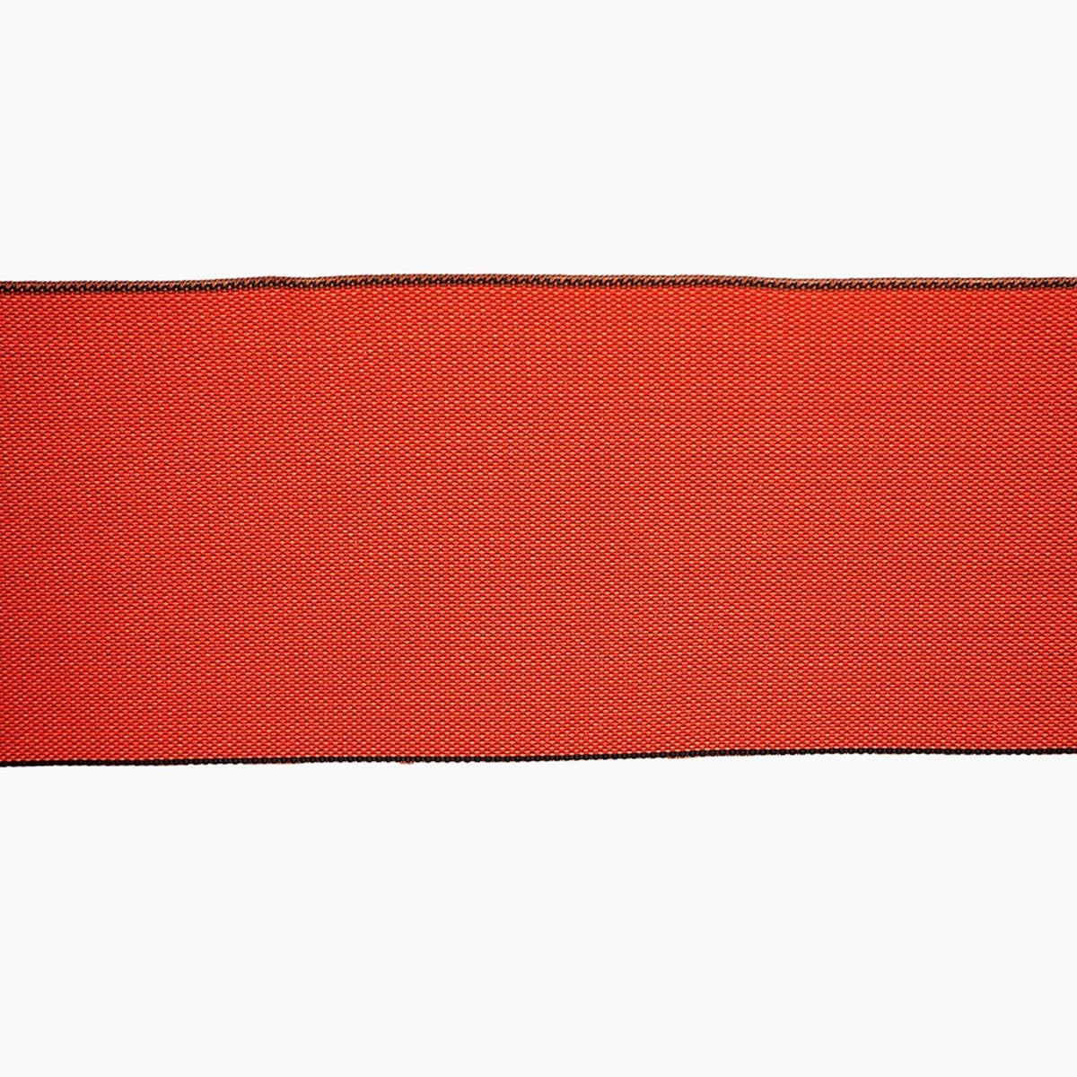 The image is a close-up of a red fabric with a black border, which appears to be a piece of clothing or textile.