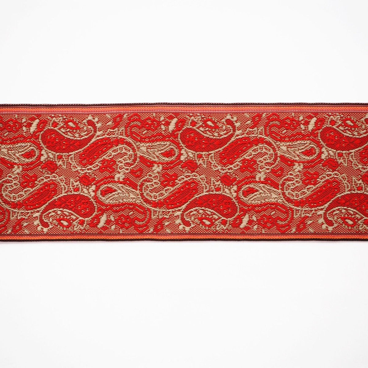 a red and gold paisley pattern with a repeating design of red and gold paisley shapes.