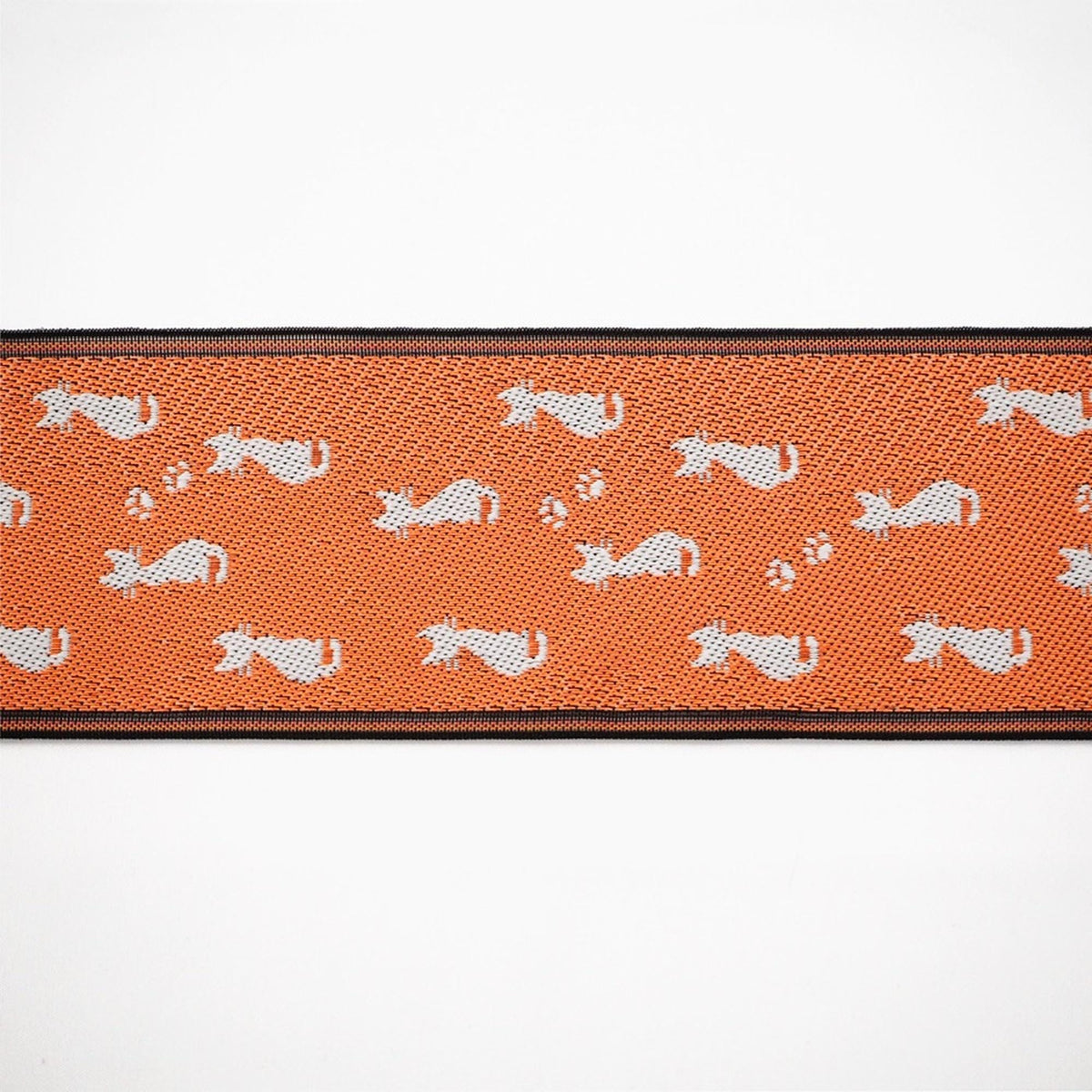 a repeating pattern of white cat silhouettes on an orange background.
