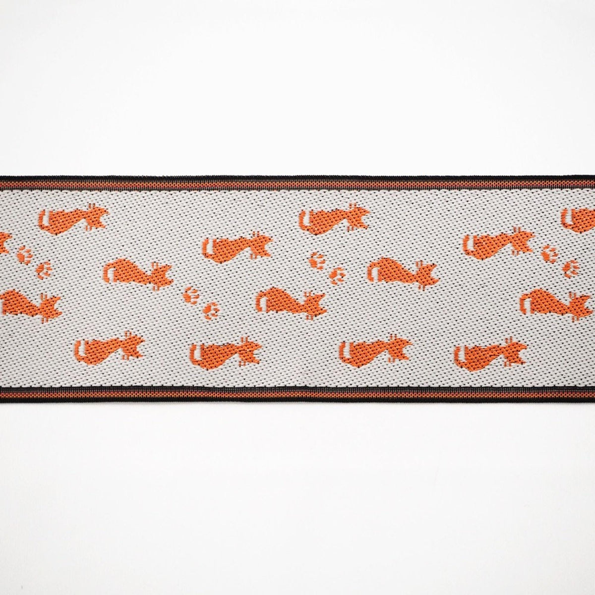 a repeating pattern of orange cat silhouettes on a white background, creating a visually striking and playful design.