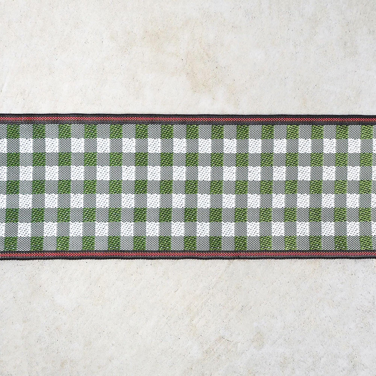 A decorative border with a checkered pattern in green and white colors, with a red border, is displayed on a plain background.