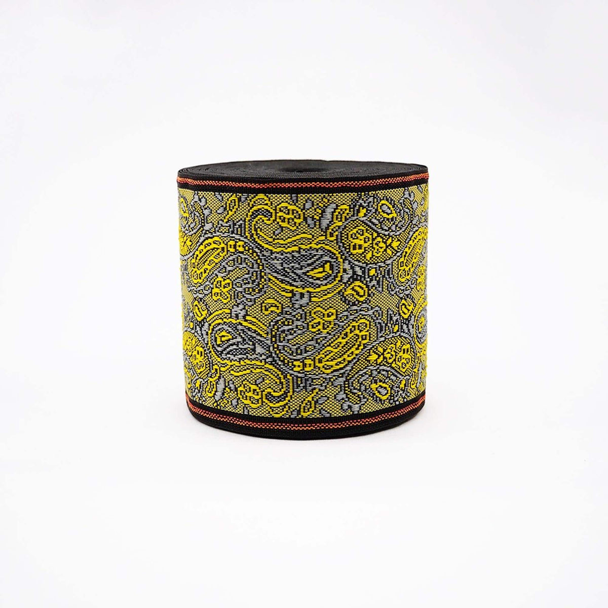 a round, black and yellow paisley-patterned object, which appears to be a decorative item or accessory.