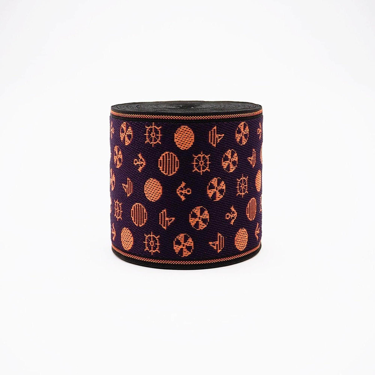 a circular object with a repeating pattern of orange and black circles and ships on a dark background.