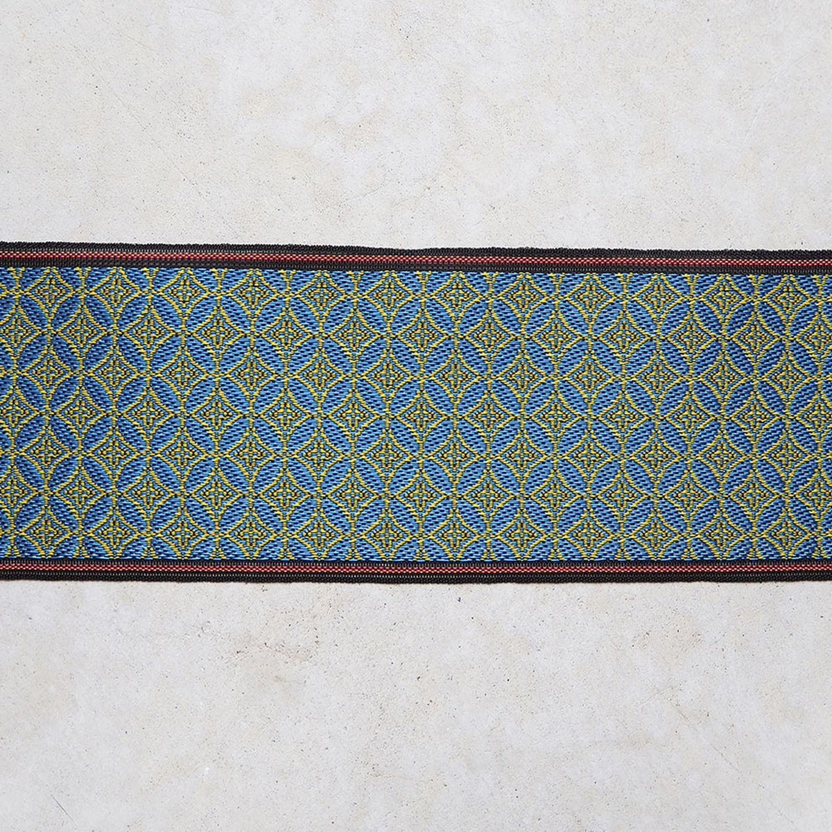 a decorative border with a repeating pattern of blue and yellow geometric shapes.