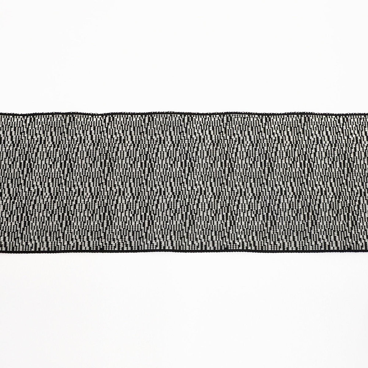 a close-up view of a black and white striped fabric or textile, with a repeating pattern of small white dots or lines creating a textured appearance.
