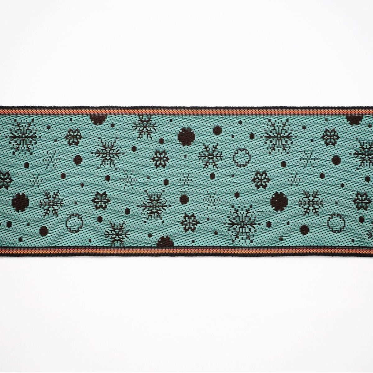 A close-up view of a fabric with a repeating pattern of snowflakes and dots in shades of blue and black.