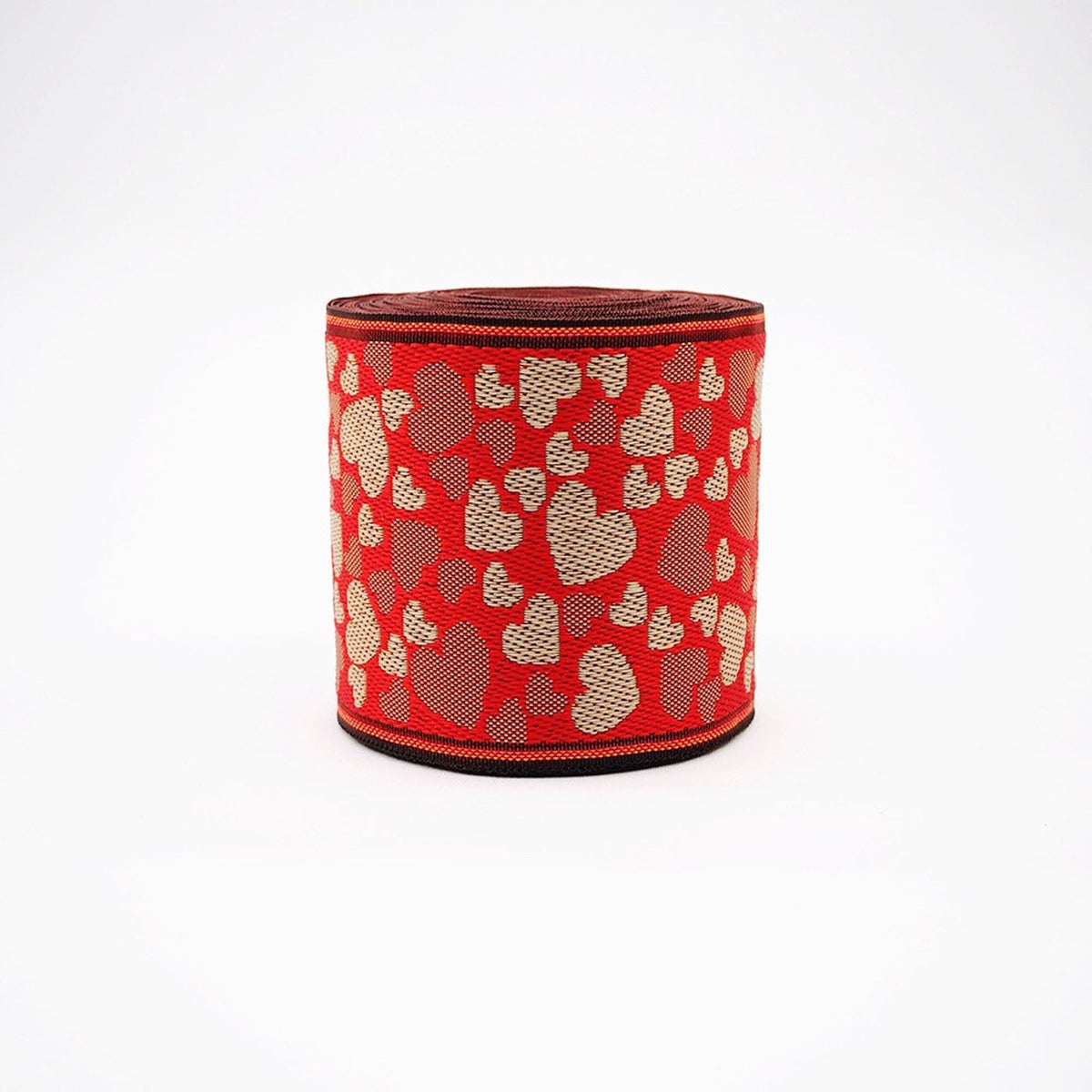 A red and white heart-patterned fabric or ribbon is shown against a white background.
