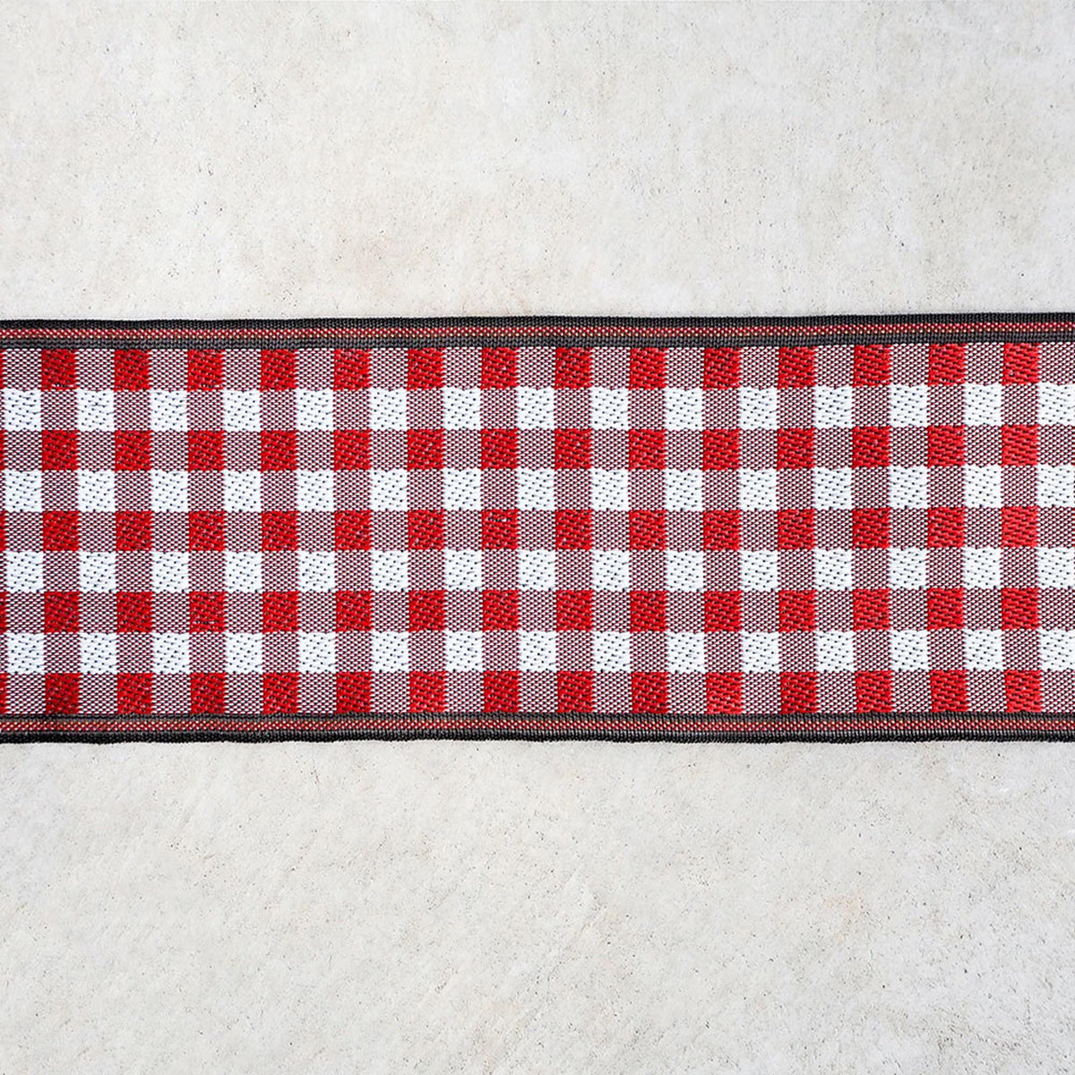 A red and white checkered pattern on a white surface.