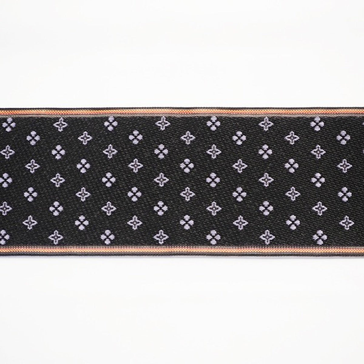 a black fabric with a repeating pattern of small white flowers or dots on it.