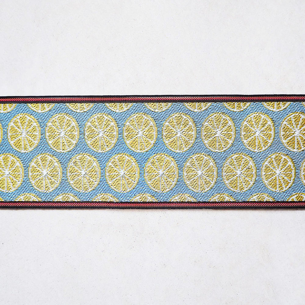 A decorative fabric with a repeating pattern of yellow and blue circles, creating a visually appealing design.