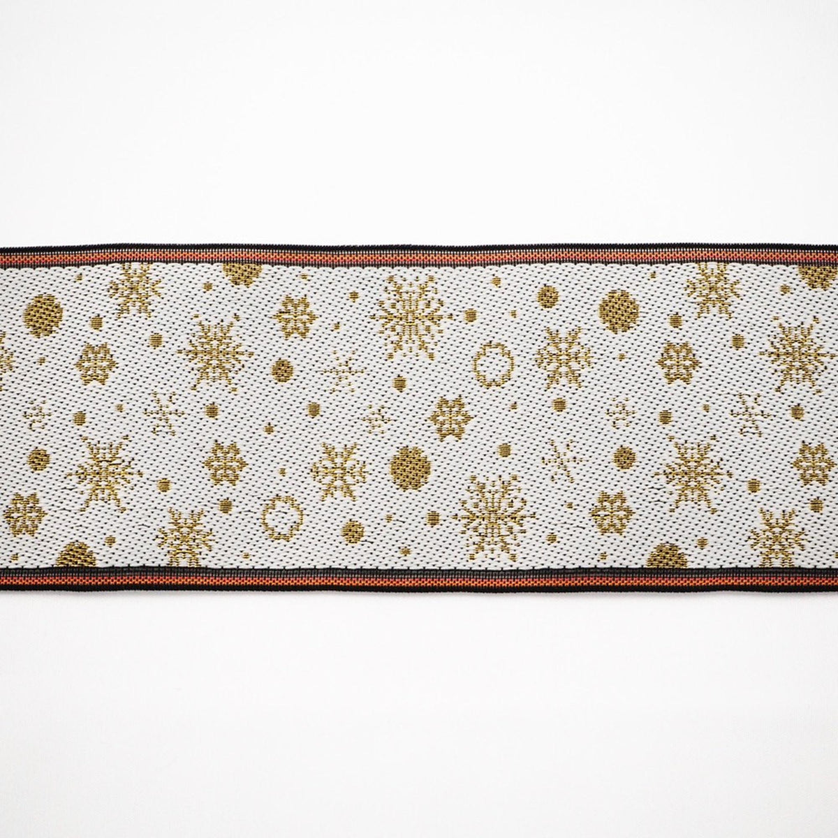 A decorative ribbon with a repeating pattern of gold snowflakes and dots on a white background.