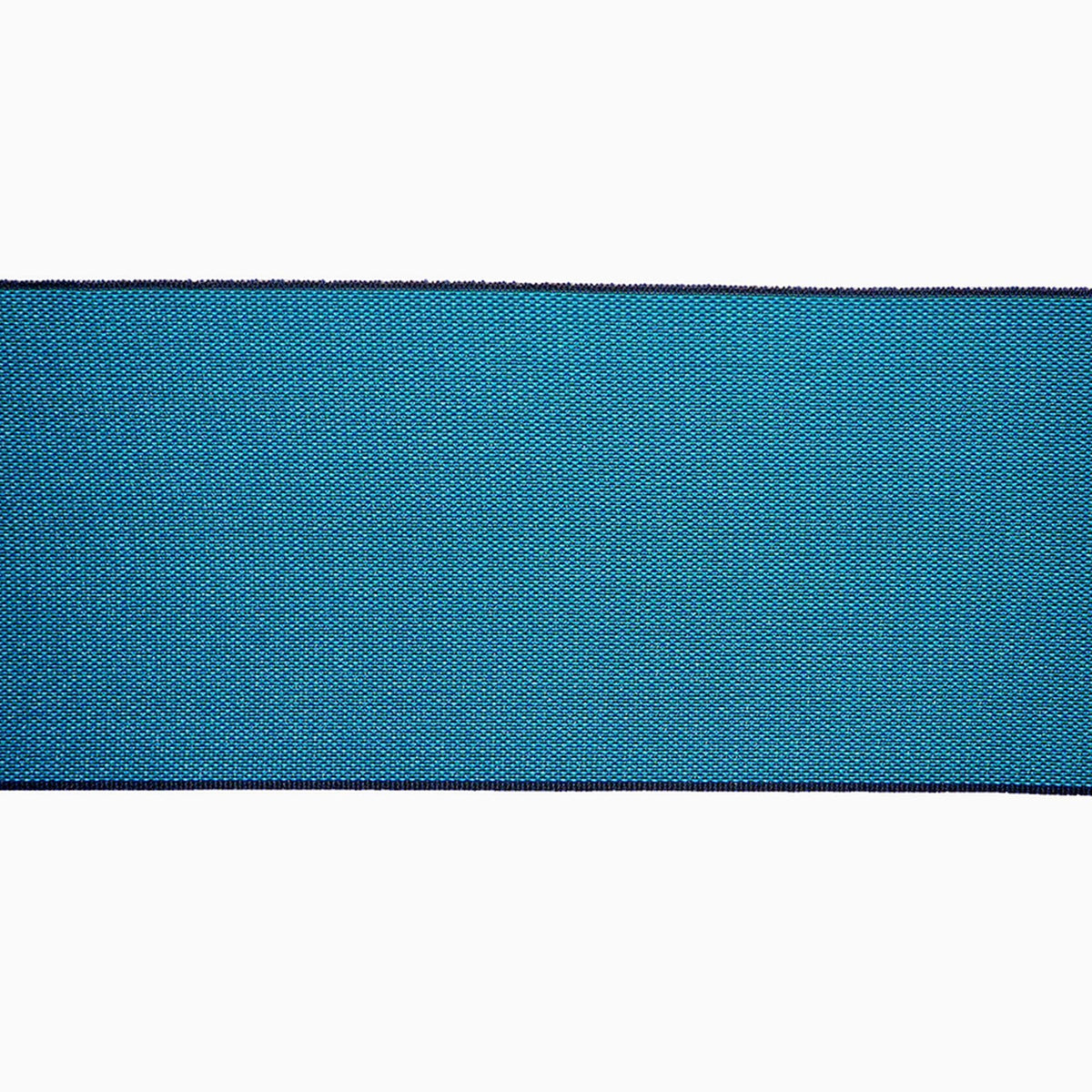 A close-up view of a blue fabric with a textured pattern, creating a visually striking contrast against the white background.