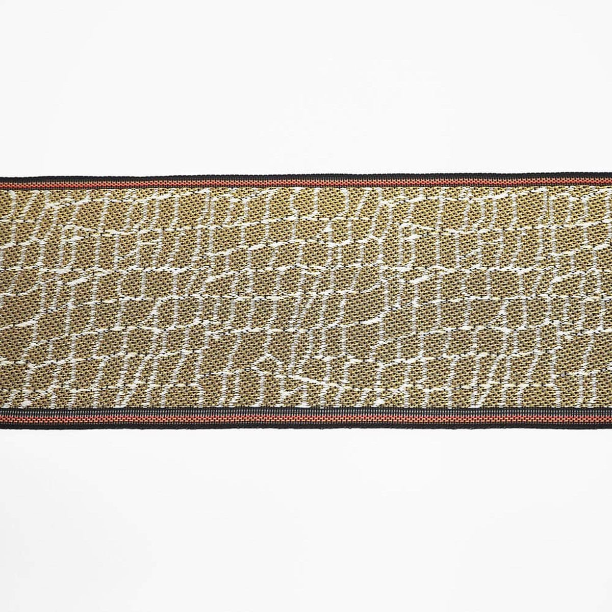 a close-up view of a textured fabric with a repeating pattern of small squares or rectangles in various shades of brown and beige.