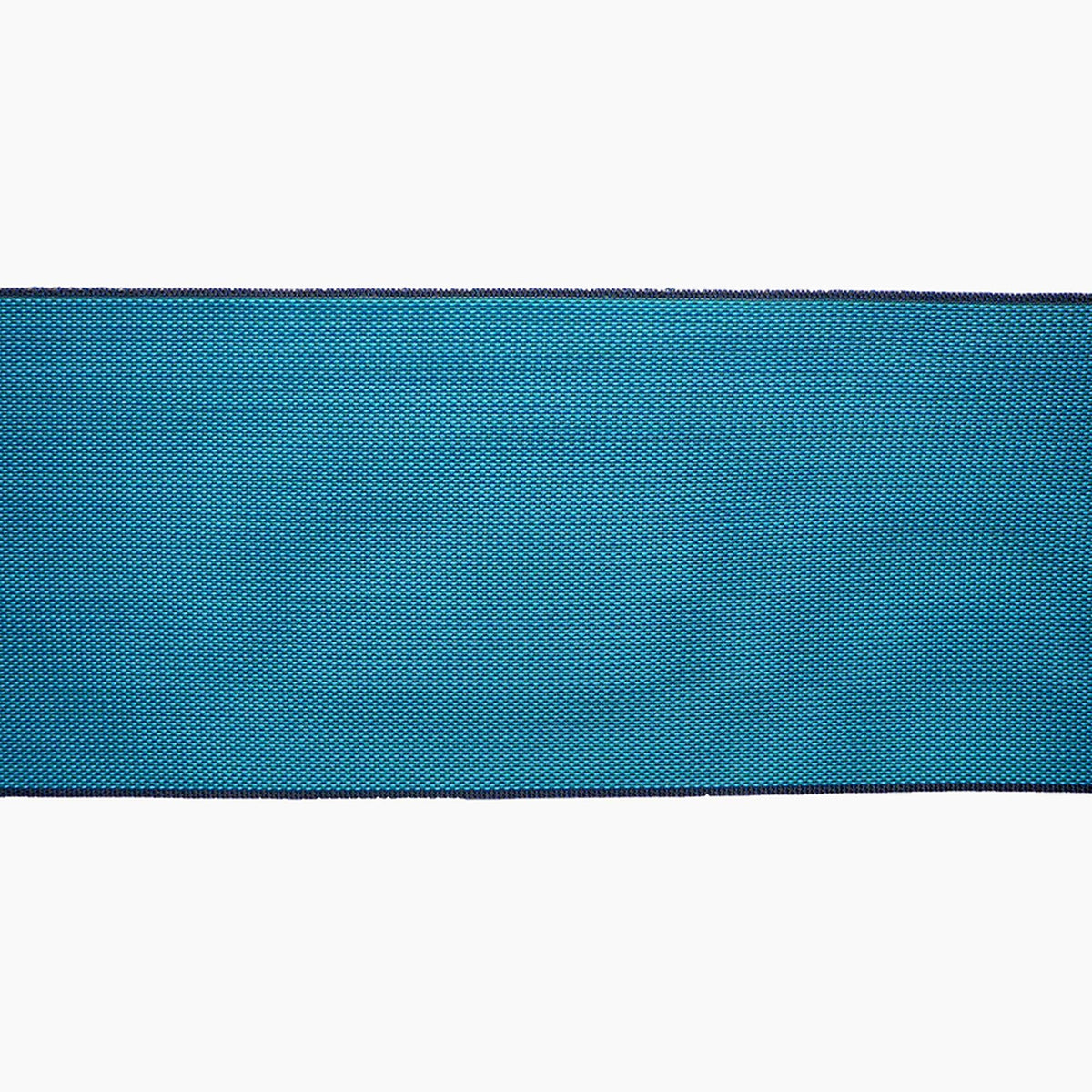 A close-up view of a blue fabric with a textured pattern, placed against a white background.