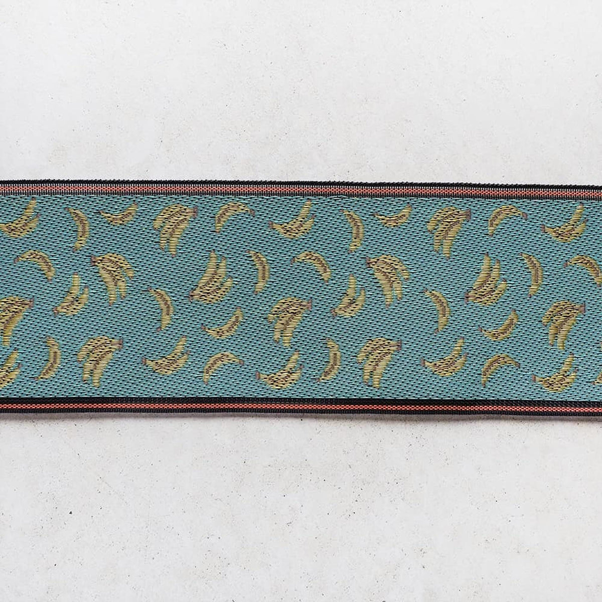 a repeating pattern of yellow bananas on a blue background.