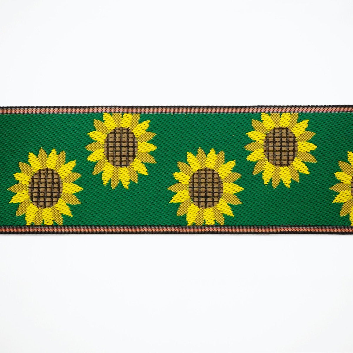 a repeating pattern of yellow sunflowers against a green background.