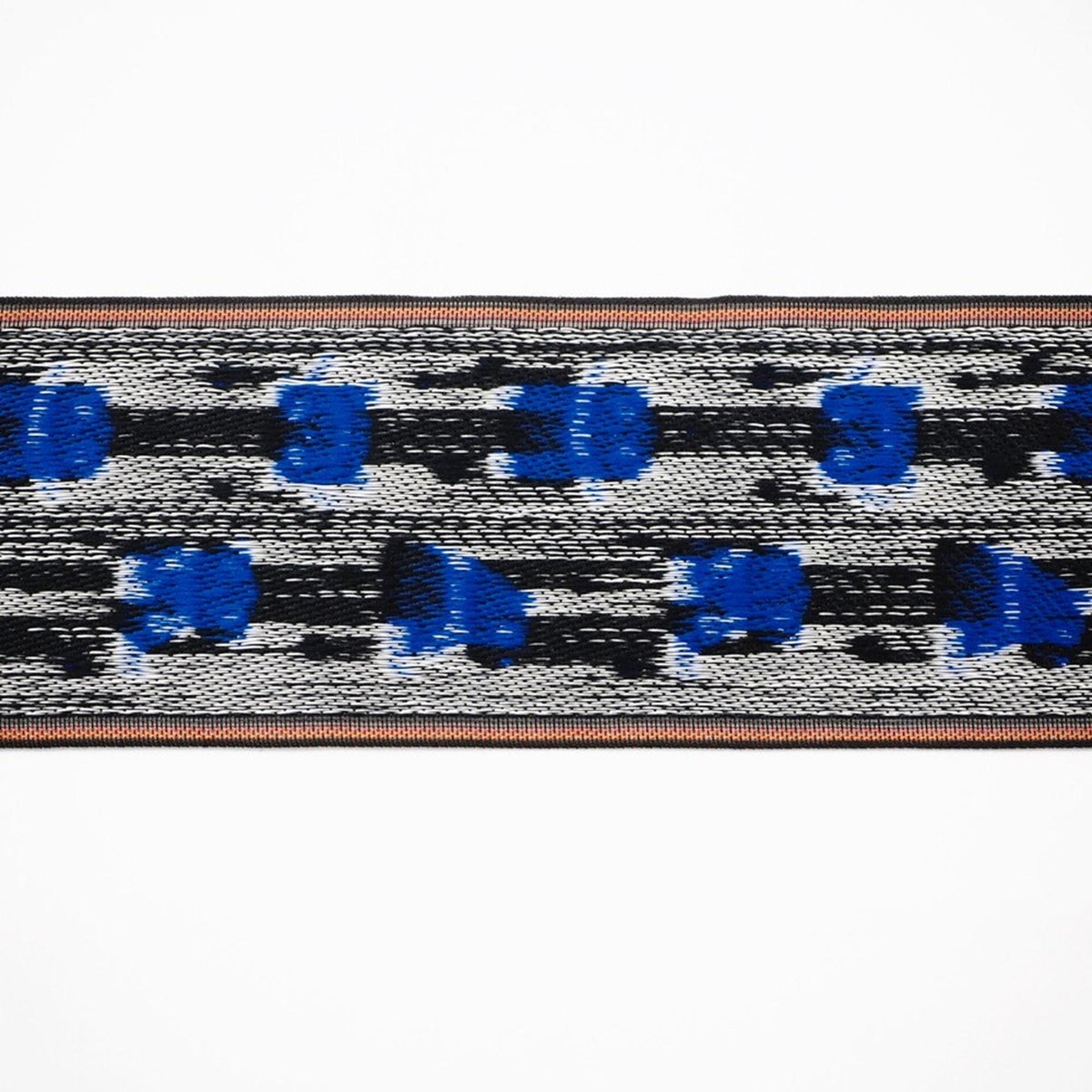 a close-up view of a textured fabric with a pattern of blue and black dots or shapes.