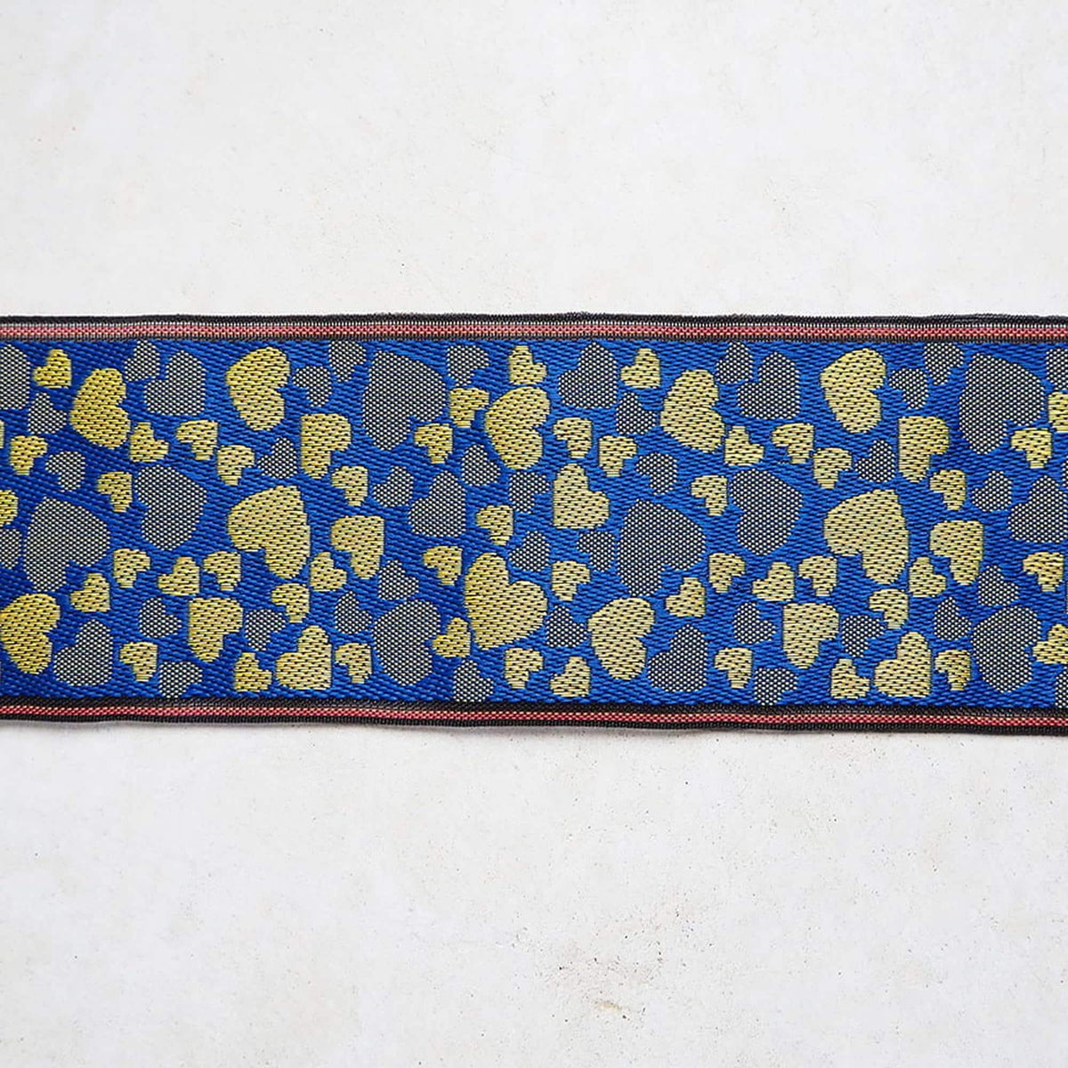 a blue and gold patterned fabric with a repeating heart shape design.